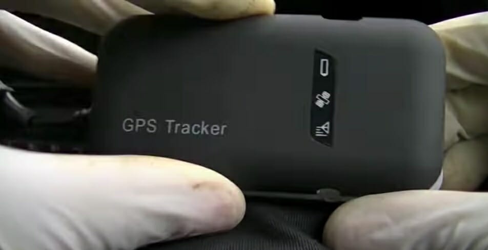 hands holding a car gps tracker